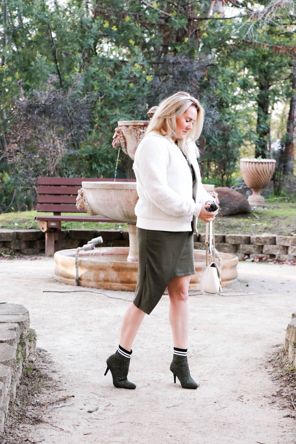Varsity Style Wearing Fuzzy Bomber Jacket and Stripe Sock Booties | Have Need Want #varsitystyle #bomberjacket #sockbooties #casualstyle #stuartweitzman