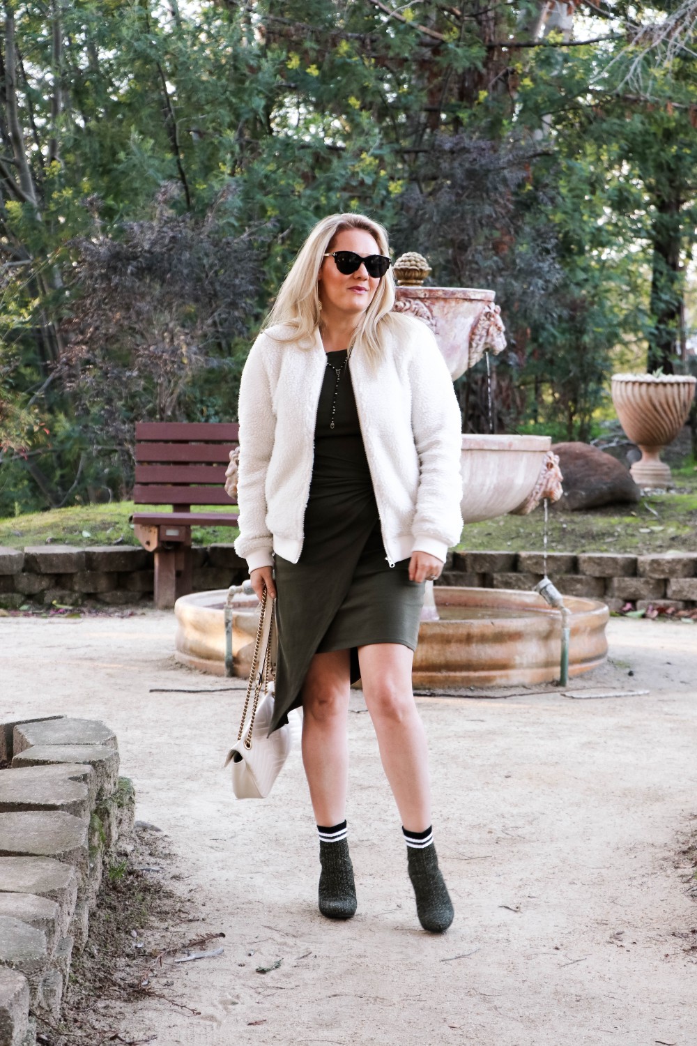 Varsity Style Wearing Fuzzy Bomber Jacket and Stripe Sock Booties | Have Need Want #varsitystyle #bomberjacket #sockbooties #casualstyle #stuartweitzman