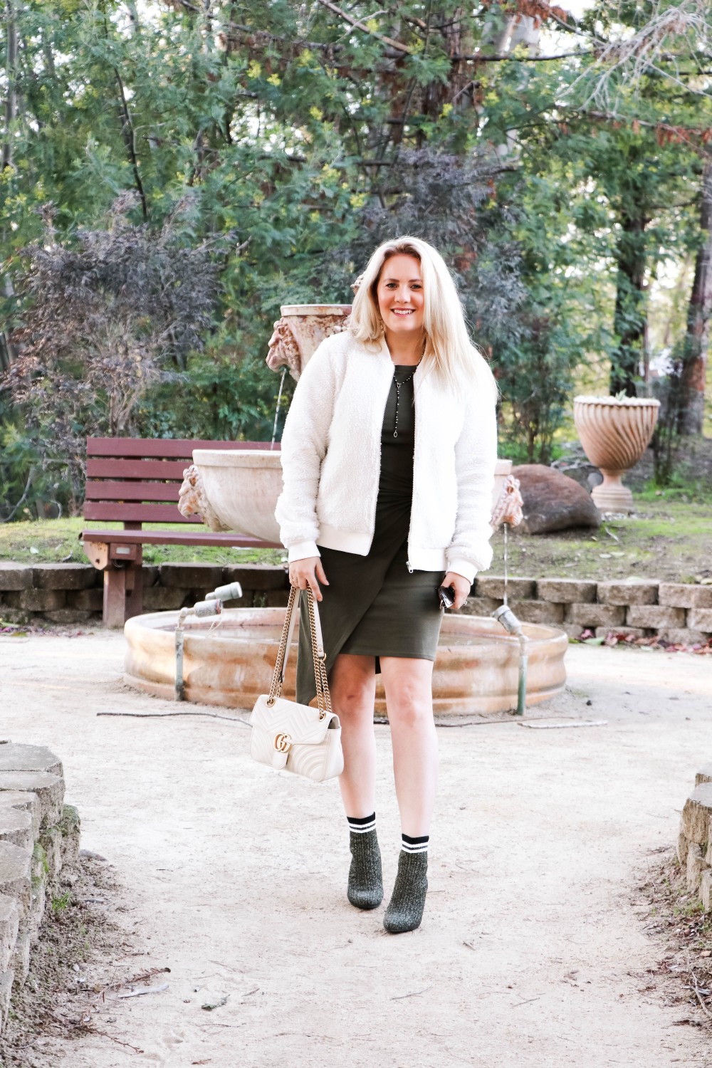 Varsity Style Wearing Fuzzy Bomber Jacket and Stripe Sock Booties | Have Need Want #varsitystyle #bomberjacket #sockbooties #casualstyle #stuartweitzman