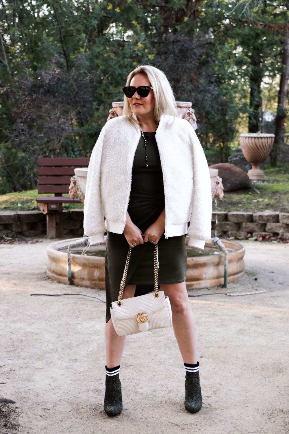 Varsity Style Wearing Fuzzy Bomber Jacket and Stripe Sock Booties | Have Need Want #varsitystyle #bomberjacket #sockbooties #casualstyle #stuartweitzman