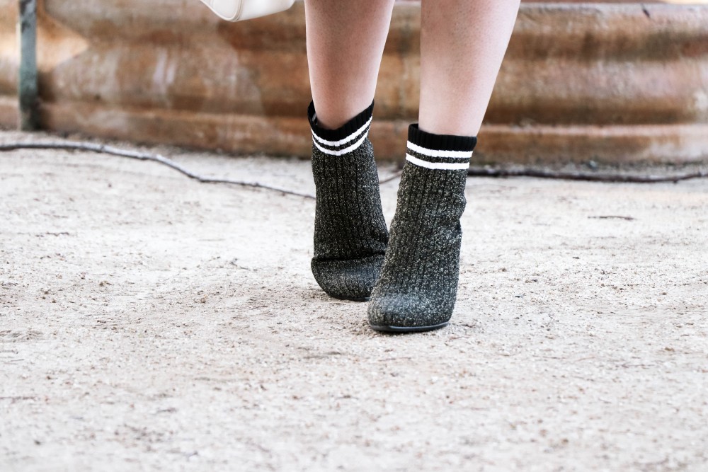 Varsity Style Wearing Fuzzy Bomber Jacket and Stripe Sock Booties | Have Need Want #varsitystyle #bomberjacket #sockbooties #casualstyle #stuartweitzman